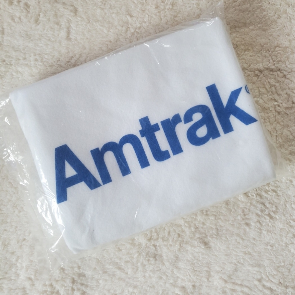 AMTRAK Train White Blanket. NEW in ORIGINAL SEALED PACKAGE.